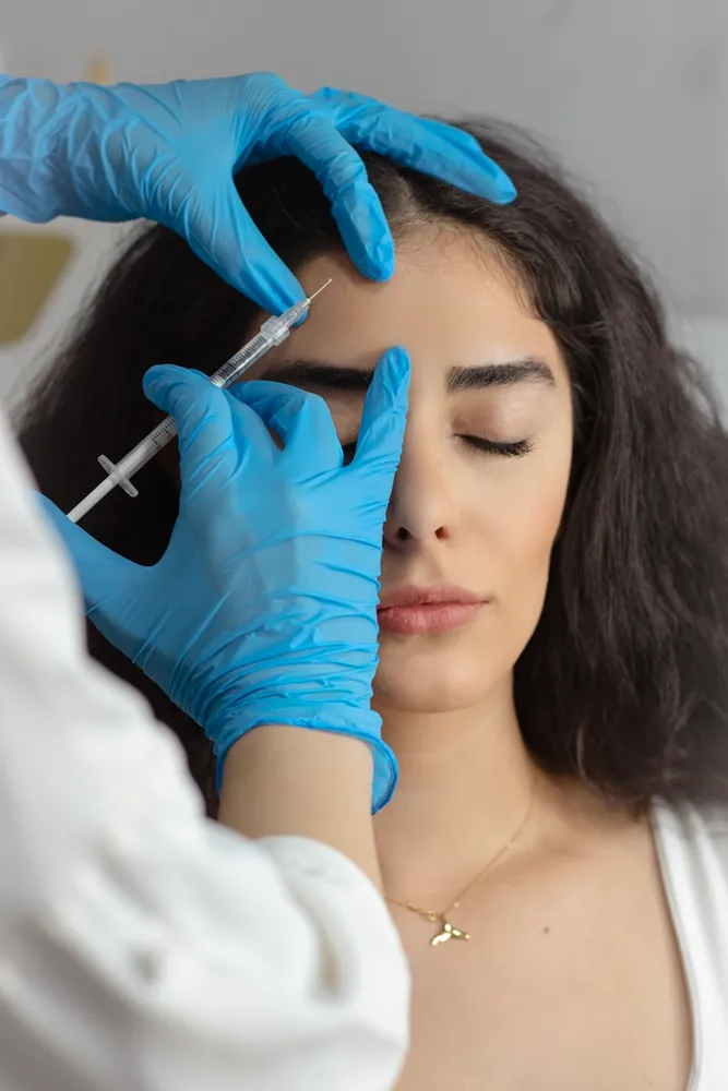 A practitioner administering a cosmetic Botox treatment.