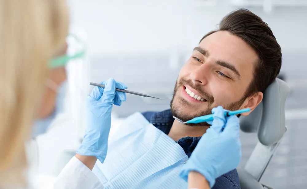 A patient and clinician at Pearly White Dentistry.