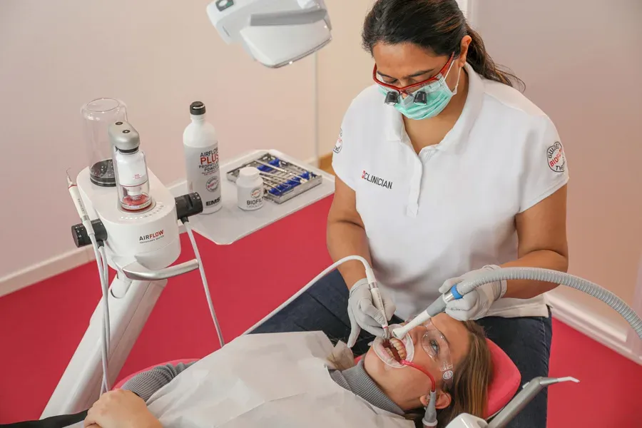 A clinician performing a preventative dental procedure at Pearly White Dentistry.